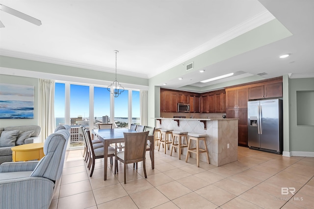 dining area with light tile patterned floors, a chandelier, recessed lighting, and crown molding