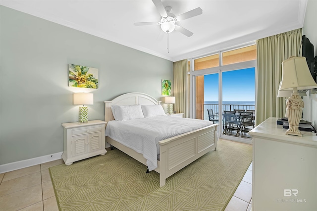 bedroom with crown molding, ceiling fan, baseboards, light tile patterned flooring, and access to outside