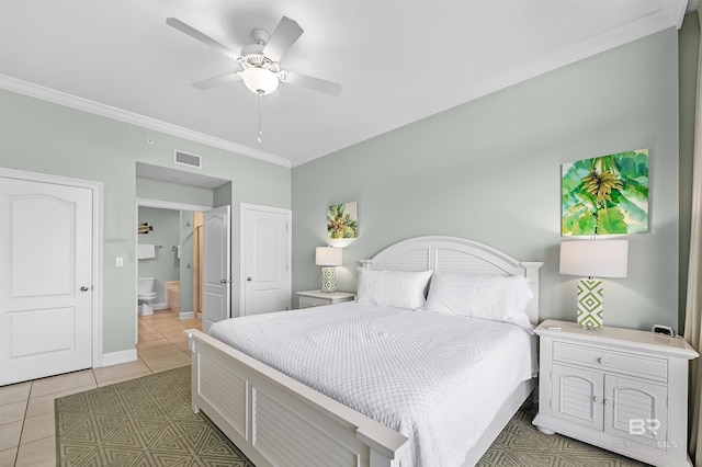 bedroom featuring visible vents, baseboards, ornamental molding, light tile patterned floors, and ensuite bath