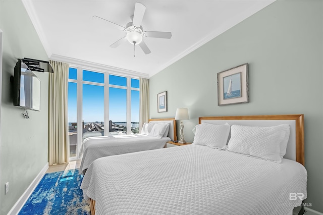 bedroom featuring a wall of windows, baseboards, a ceiling fan, and crown molding