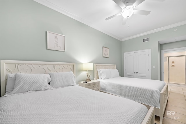 bedroom featuring a closet, visible vents, a ceiling fan, and ornamental molding