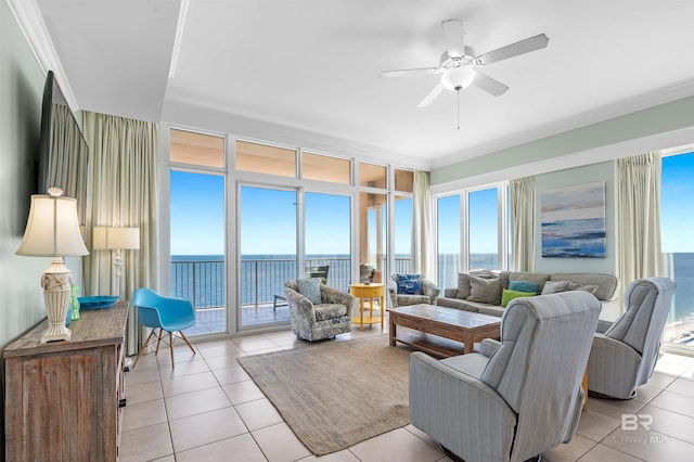 living room with light tile patterned floors, plenty of natural light, a water view, and ornamental molding