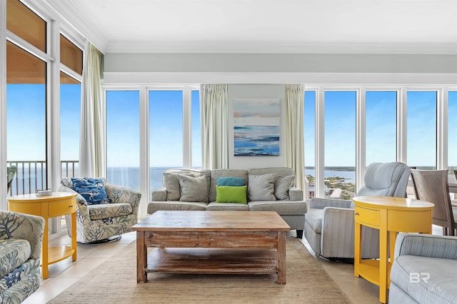 living area with light tile patterned floors, crown molding, and a water view