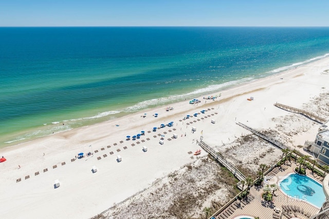 birds eye view of property with a beach view and a water view