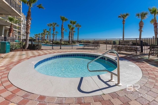 view of pool with a hot tub