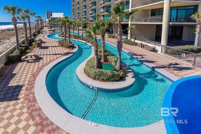 view of swimming pool with a water view