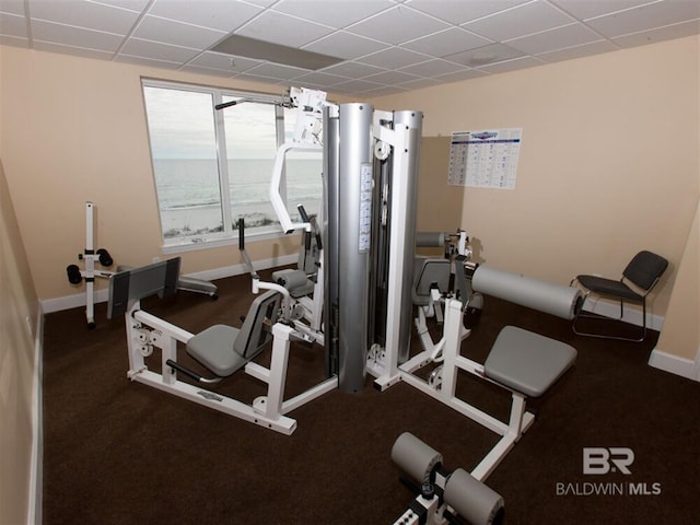 workout room with a paneled ceiling