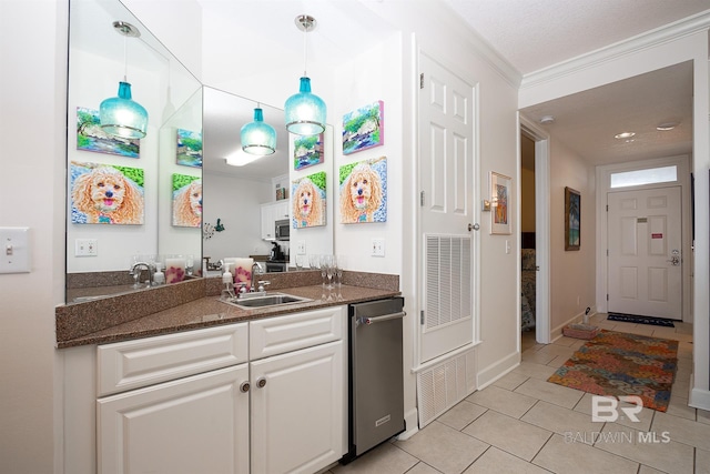 kitchen with light tile patterned flooring, decorative light fixtures, sink, white cabinets, and ornamental molding