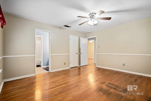 5175 W Somerset Dr, Mobile, AL 36619 - unfurnished bedroom with wood finished floors, baseboards, ensuite bathroom, and ceiling fan