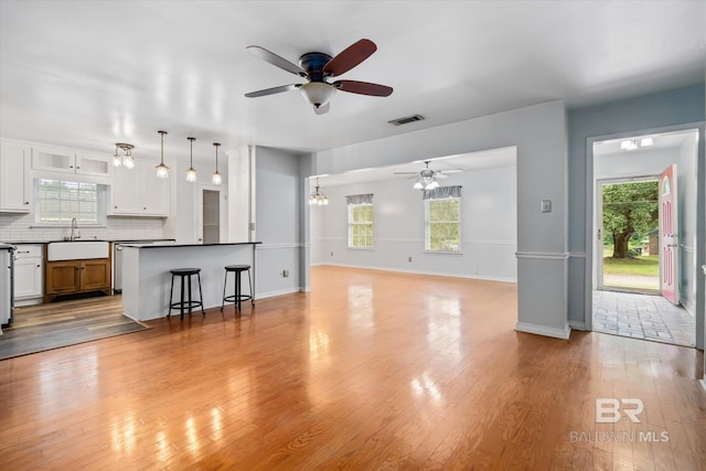 5175 W Somerset Dr, Mobile, AL 36619 - living room with ceiling fan, plenty of natural light, light wood-style floors, and baseboards