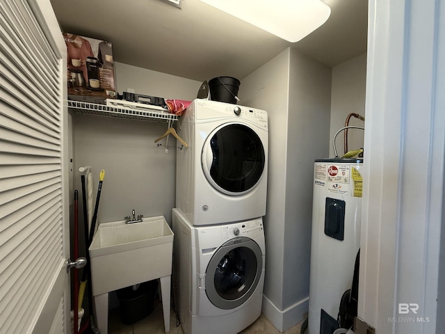 28105 Perdido Beach Blvd Unit C211, Orange Beach, AL 36561 - laundry room with laundry area, stacked washer and dryer, a sink, and water heater