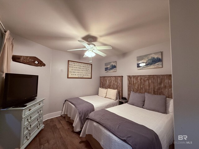 28105 Perdido Beach Blvd Unit C211, Orange Beach, AL 36561 - bedroom with baseboards, a ceiling fan, and dark wood finished floors