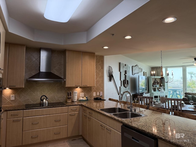 28105 Perdido Beach Blvd Unit C211, Orange Beach, AL 36561 - kitchen with wall chimney exhaust hood, light brown cabinets, a sink, black appliances, and decorative backsplash