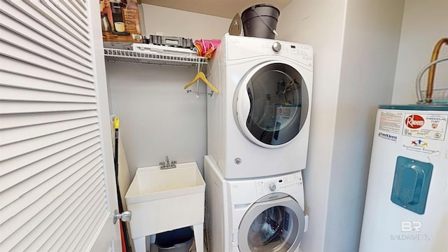 28105 Perdido Beach Blvd Unit C211, Orange Beach, AL 36561 - clothes washing area featuring a sink, water heater, stacked washer and dryer, and laundry area