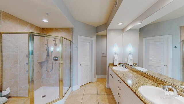 28105 Perdido Beach Blvd Unit C211, Orange Beach, AL 36561 - bathroom with a shower stall, double vanity, and a sink
