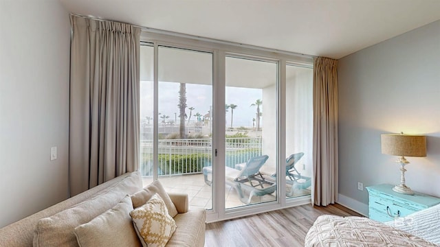 28105 Perdido Beach Blvd Unit C211, Orange Beach, AL 36561 - bedroom with access to outside, wood finished floors, baseboards, and floor to ceiling windows