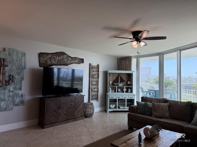 28105 Perdido Beach Blvd Unit C211, Orange Beach, AL 36561 - tiled living room featuring baseboards and a ceiling fan