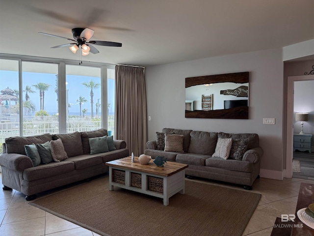 28105 Perdido Beach Blvd Unit C211, Orange Beach, AL 36561 - living area with light tile patterned floors, ceiling fan, and baseboards