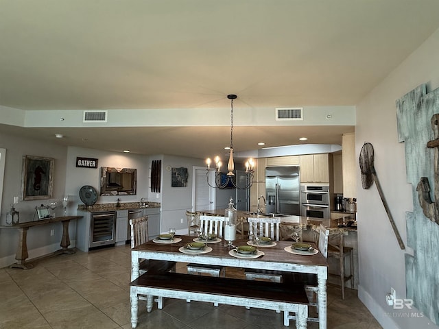 28105 Perdido Beach Blvd Unit C211, Orange Beach, AL 36561 - dining space with visible vents, a notable chandelier, beverage cooler, and baseboards