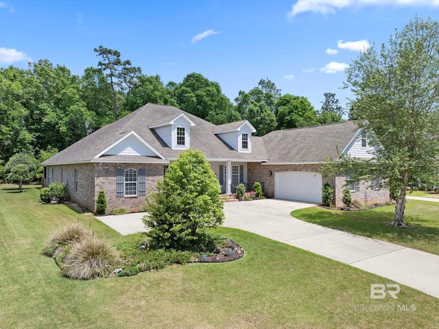 8664 Foxtail Loop, Pensacola, FL 32526 - view of front of property with brick siding, driveway, a garage, and a front lawn