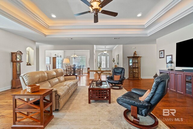 8664 Foxtail Loop, Pensacola, FL 32526 - living room featuring a raised ceiling, a ceiling fan, crown molding, a chandelier, and recessed lighting