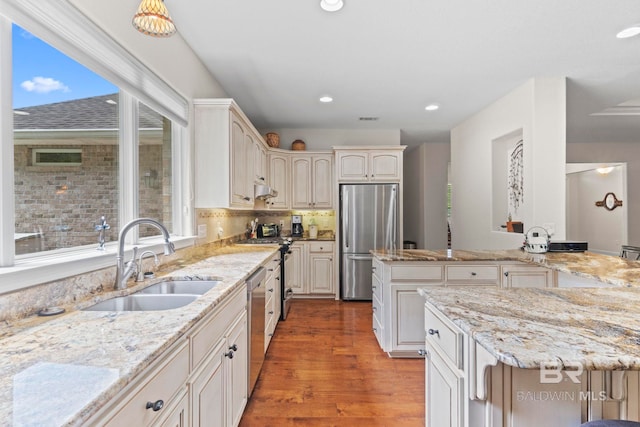 8664 Foxtail Loop, Pensacola, FL 32526 - kitchen featuring a sink, stainless steel appliances, recessed lighting, light stone counters, and light wood-style floors