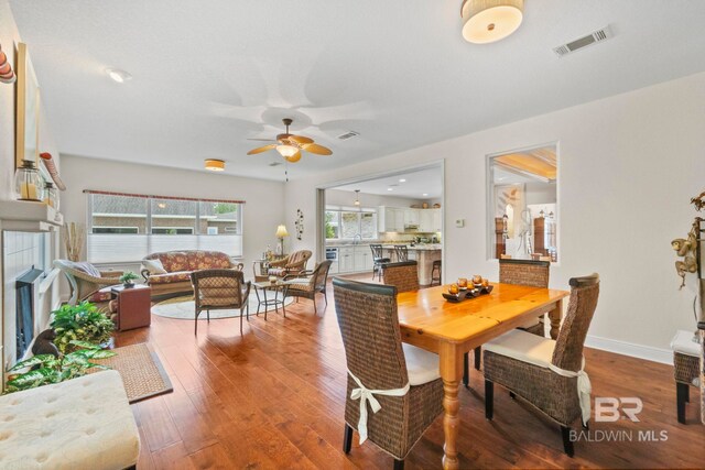 8664 Foxtail Loop, Pensacola, FL 32526 - dining area featuring wood finished floors, a ceiling fan, and baseboards