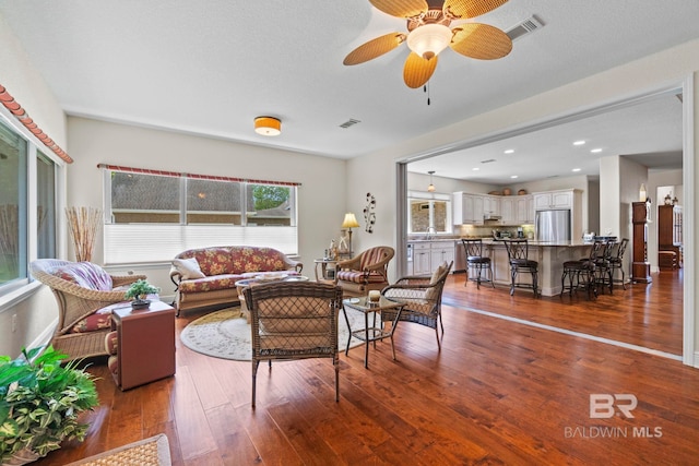 8664 Foxtail Loop, Pensacola, FL 32526 - living room featuring healthy amount of natural light, wood-type flooring, and a ceiling fan