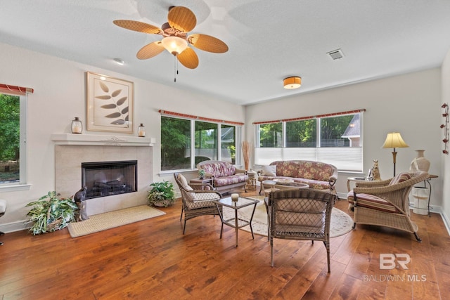 8664 Foxtail Loop, Pensacola, FL 32526 - living area with plenty of natural light, hardwood / wood-style floors, a ceiling fan, and a tile fireplace