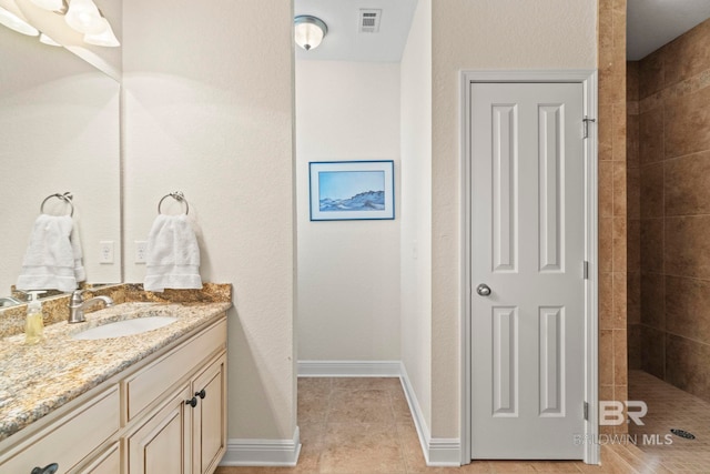 8664 Foxtail Loop, Pensacola, FL 32526 - full bath with vanity, a tile shower, baseboards, and tile patterned flooring
