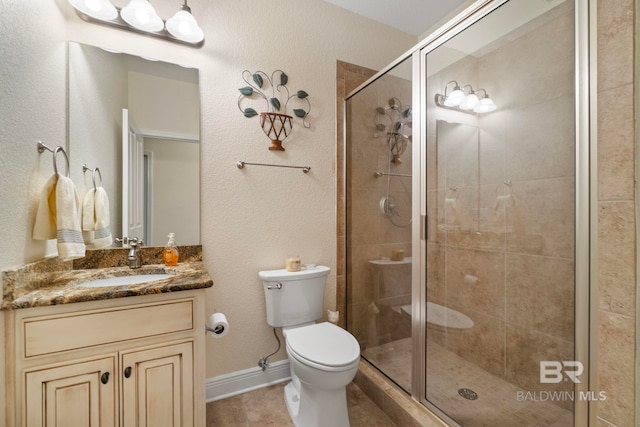 8664 Foxtail Loop, Pensacola, FL 32526 - bathroom with a shower stall, toilet, vanity, and tile patterned floors
