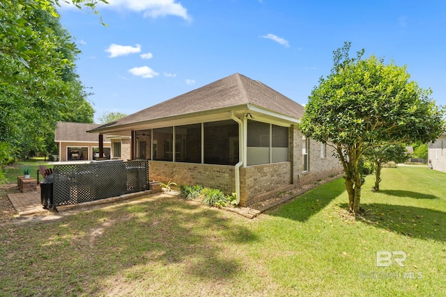 8664 Foxtail Loop, Pensacola, FL 32526 - rear view of property with a sunroom, brick siding, and a lawn
