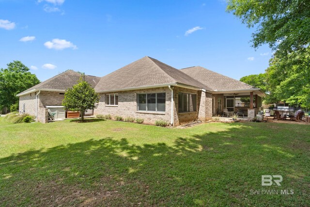 8664 Foxtail Loop, Pensacola, FL 32526 - rear view of property featuring a ceiling fan, a patio, a yard, brick siding, and a shingled roof