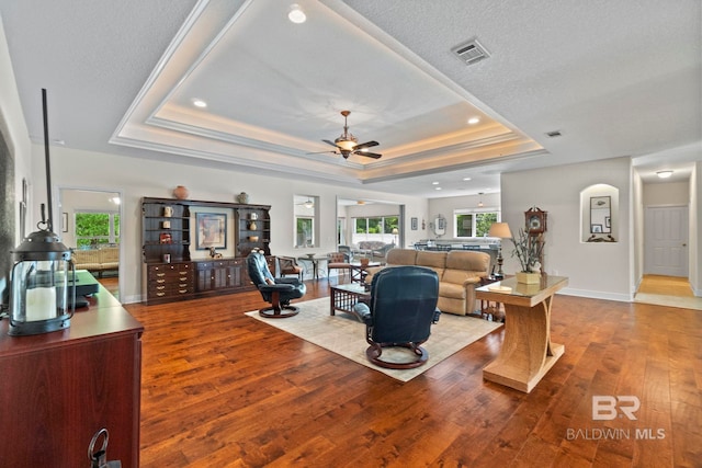 8664 Foxtail Loop, Pensacola, FL 32526 - living room with a tray ceiling, a ceiling fan, wood finished floors, recessed lighting, and baseboards