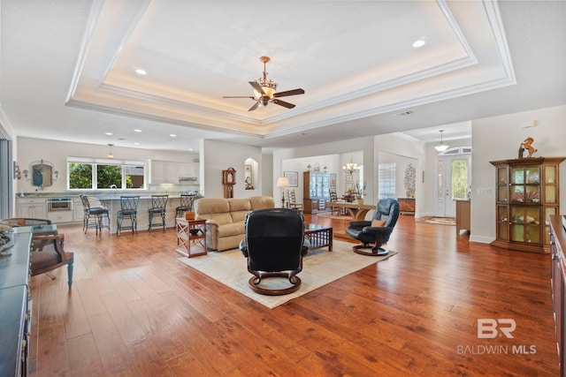 8664 Foxtail Loop, Pensacola, FL 32526 - living room featuring a raised ceiling, ceiling fan, hardwood / wood-style flooring, recessed lighting, and crown molding