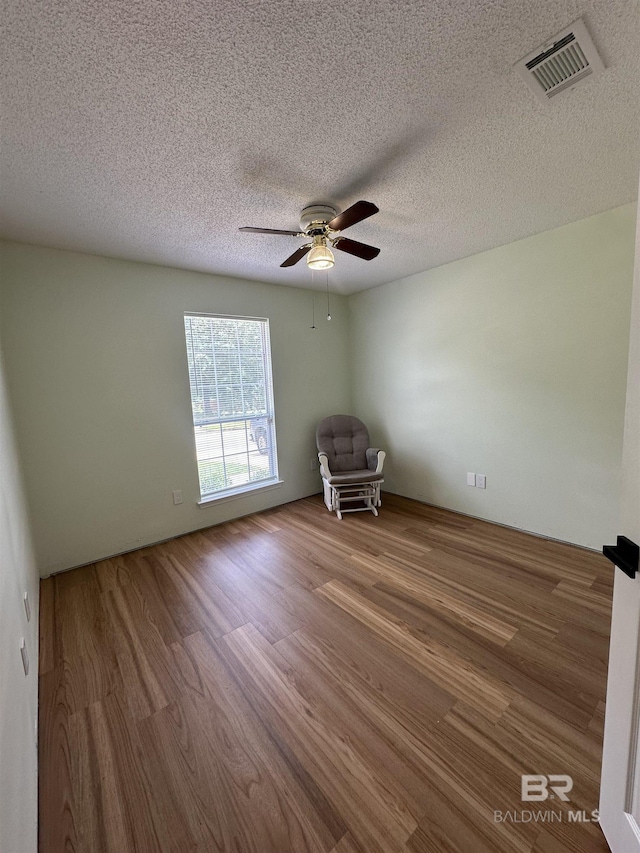 1010 E Hamilton Bridges Dr, Mobile, AL 36695 - spare room featuring wood finished floors, ceiling fan, and a textured ceiling