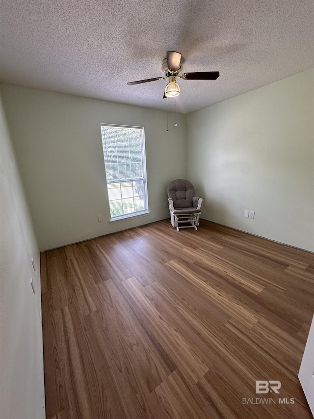 1010 E Hamilton Bridges Dr, Mobile, AL 36695 - empty room featuring wood finished floors, a textured ceiling, and ceiling fan