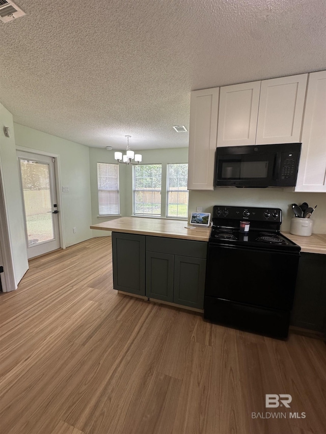 1010 E Hamilton Bridges Dr, Mobile, AL 36695 - kitchen with black appliances, a chandelier, light wood-style floors, white cabinetry, and light countertops