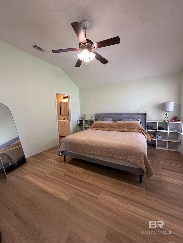 1010 E Hamilton Bridges Dr, Mobile, AL 36695 - bedroom with lofted ceiling, wood finished floors, a ceiling fan, ensuite bathroom, and a textured ceiling