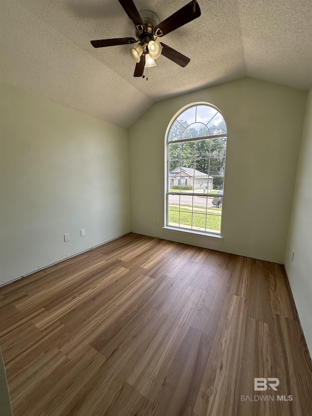 1010 E Hamilton Bridges Dr, Mobile, AL 36695 - empty room featuring vaulted ceiling, wood finished floors, ceiling fan, and a textured ceiling
