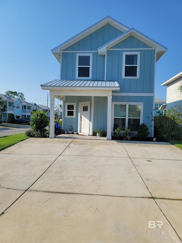 23965 Cottage Loop, Orange Beach, AL 36561 - view of front facade featuring board and batten siding, covered porch, a standing seam roof, and metal roof