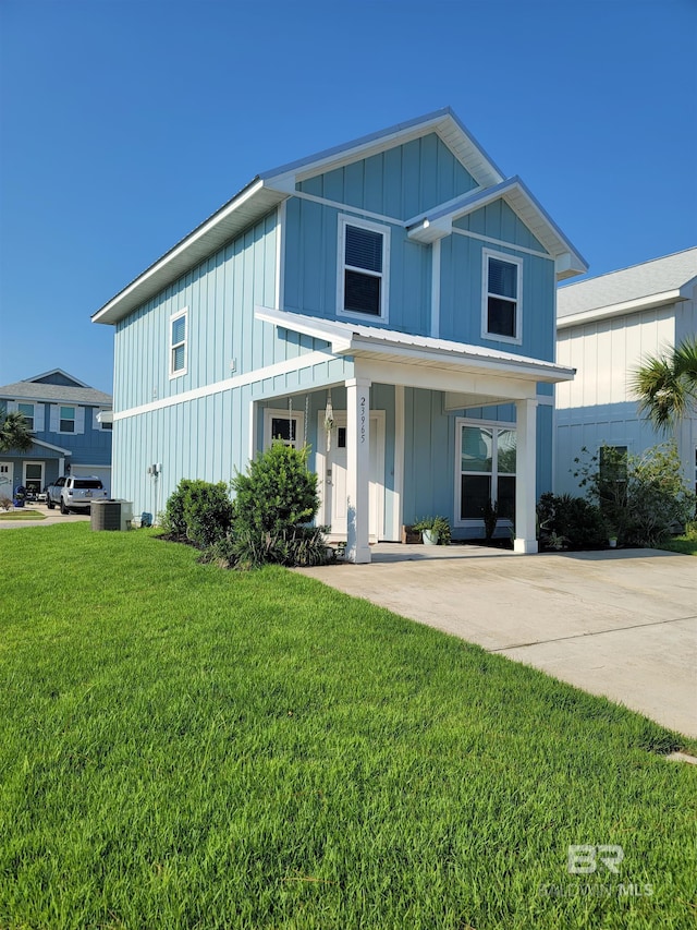 23965 Cottage Loop, Orange Beach, AL 36561 - view of front facade featuring board and batten siding, a front yard, and a porch