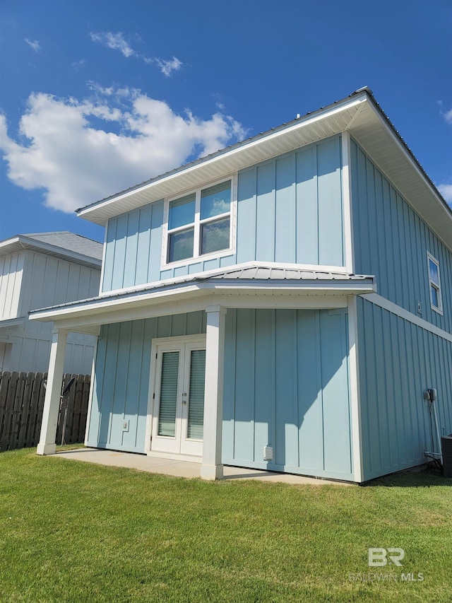 23965 Cottage Loop, Orange Beach, AL 36561 - back of property featuring board and batten siding, french doors, and a patio area