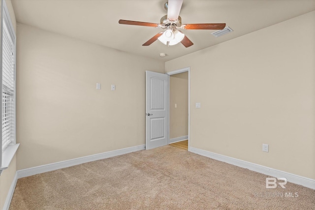 interior space featuring light carpet and ceiling fan