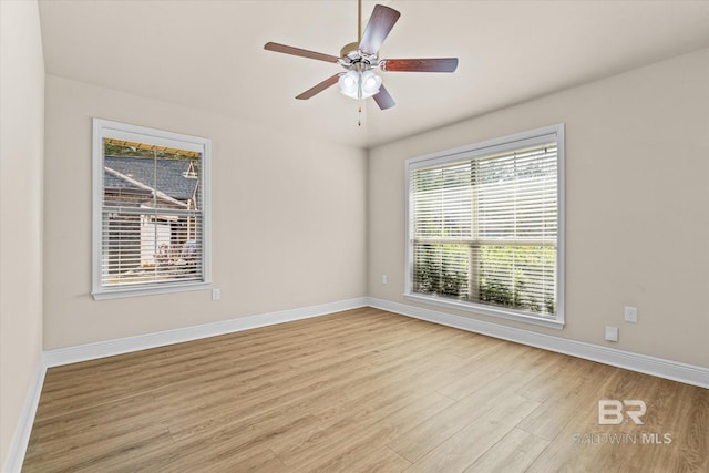 spare room with ceiling fan and light wood-type flooring