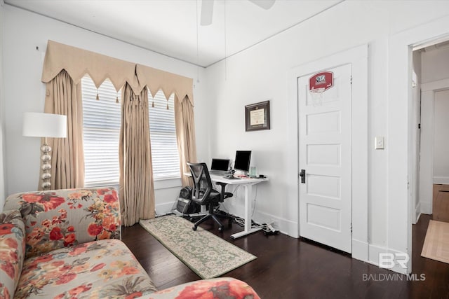 home office with ceiling fan and dark wood-type flooring