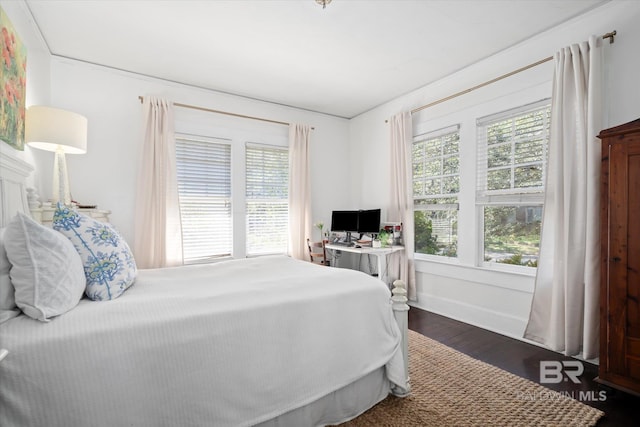 bedroom with dark wood-type flooring