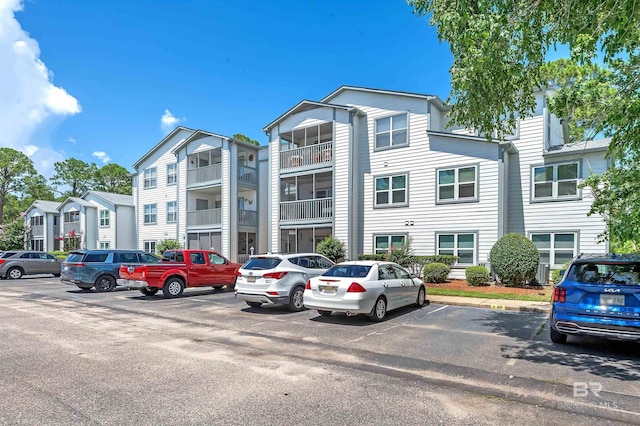2200 W 2nd St Unit 301-C, Gulf Shores, AL 36542 - view of building exterior featuring uncovered parking