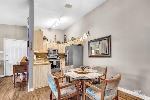 2200 W 2nd St Unit 301-C, Gulf Shores, AL 36542 - dining area with light wood-style floors and track lighting