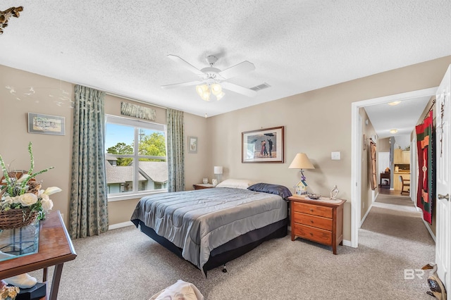 2200 W 2nd St Unit 301-C, Gulf Shores, AL 36542 - bedroom with light colored carpet, a textured ceiling, and a ceiling fan